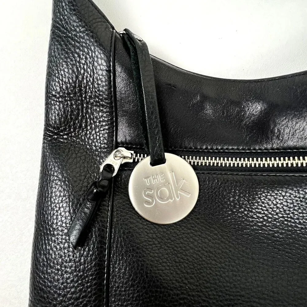 The Sak Hobo Shoulder Bag Pebbled Black Leather Pockets Signature Charm Roomy
